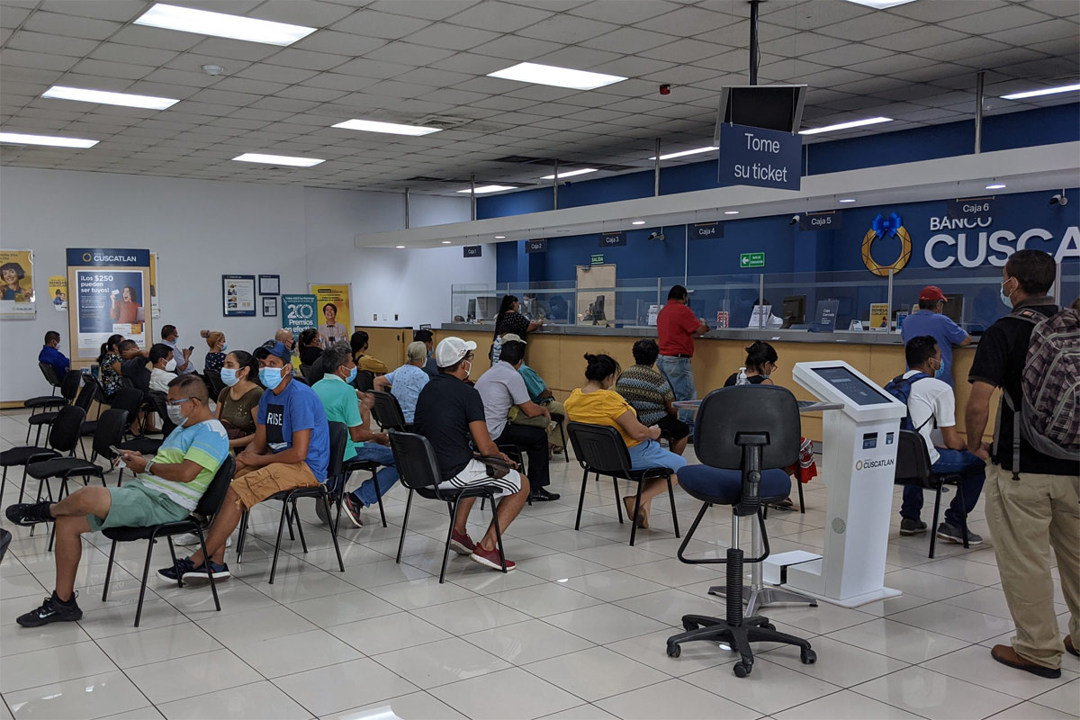 Unbanked people waiting at a bank in Sonsonate to cash out their pay check